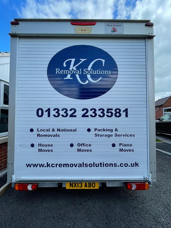 Rear of a KC Removal Solutions removal van listing their services