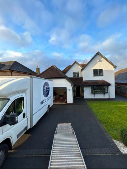 KC Removal Solutions van with loading ramp at a large detached home