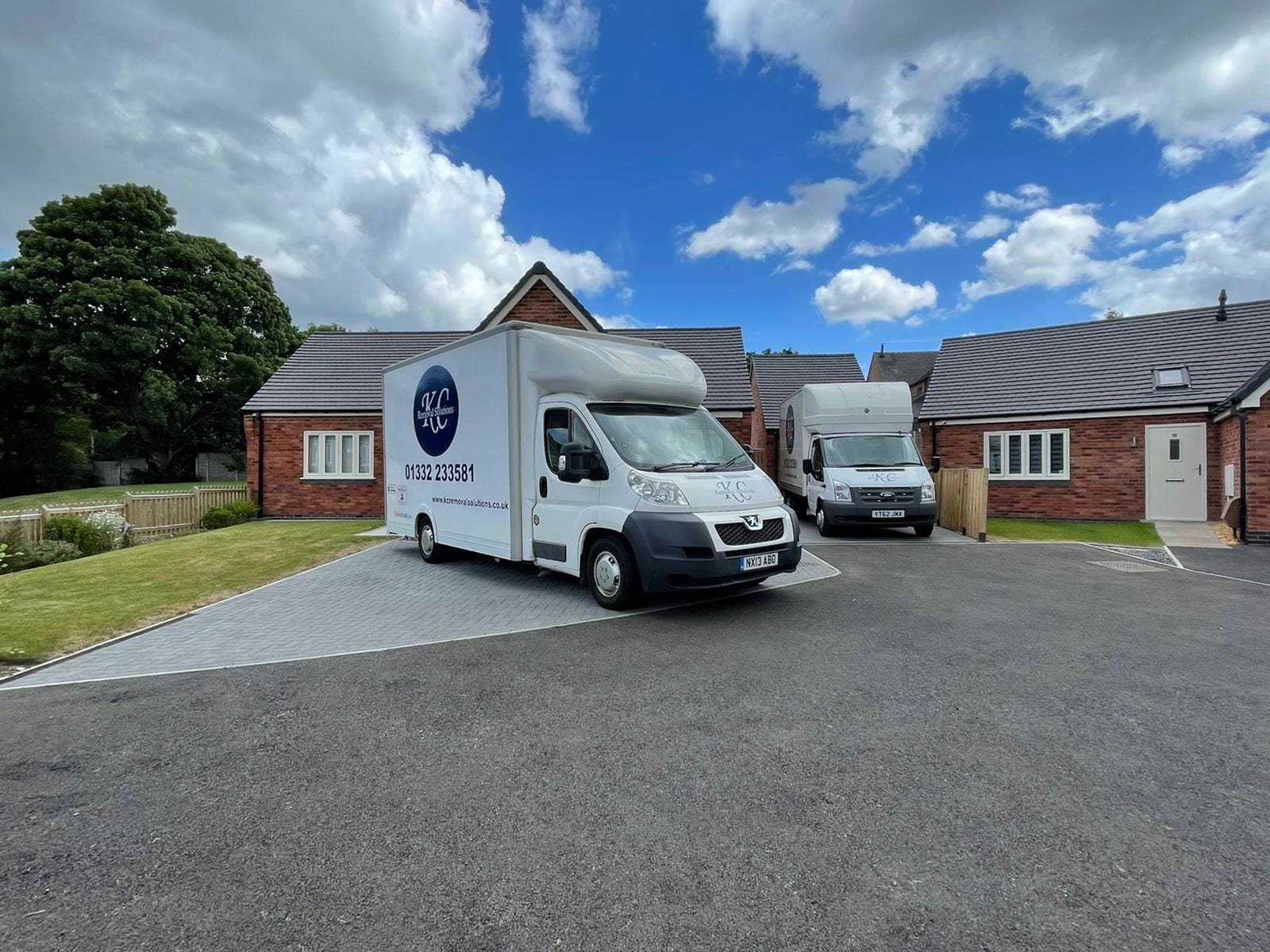 Two KC Removal Solutions vans at a Derby property on moving day